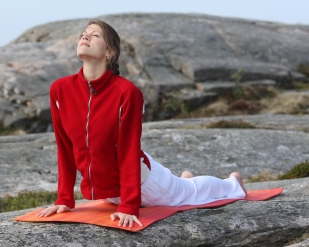young woman excercising power yoga